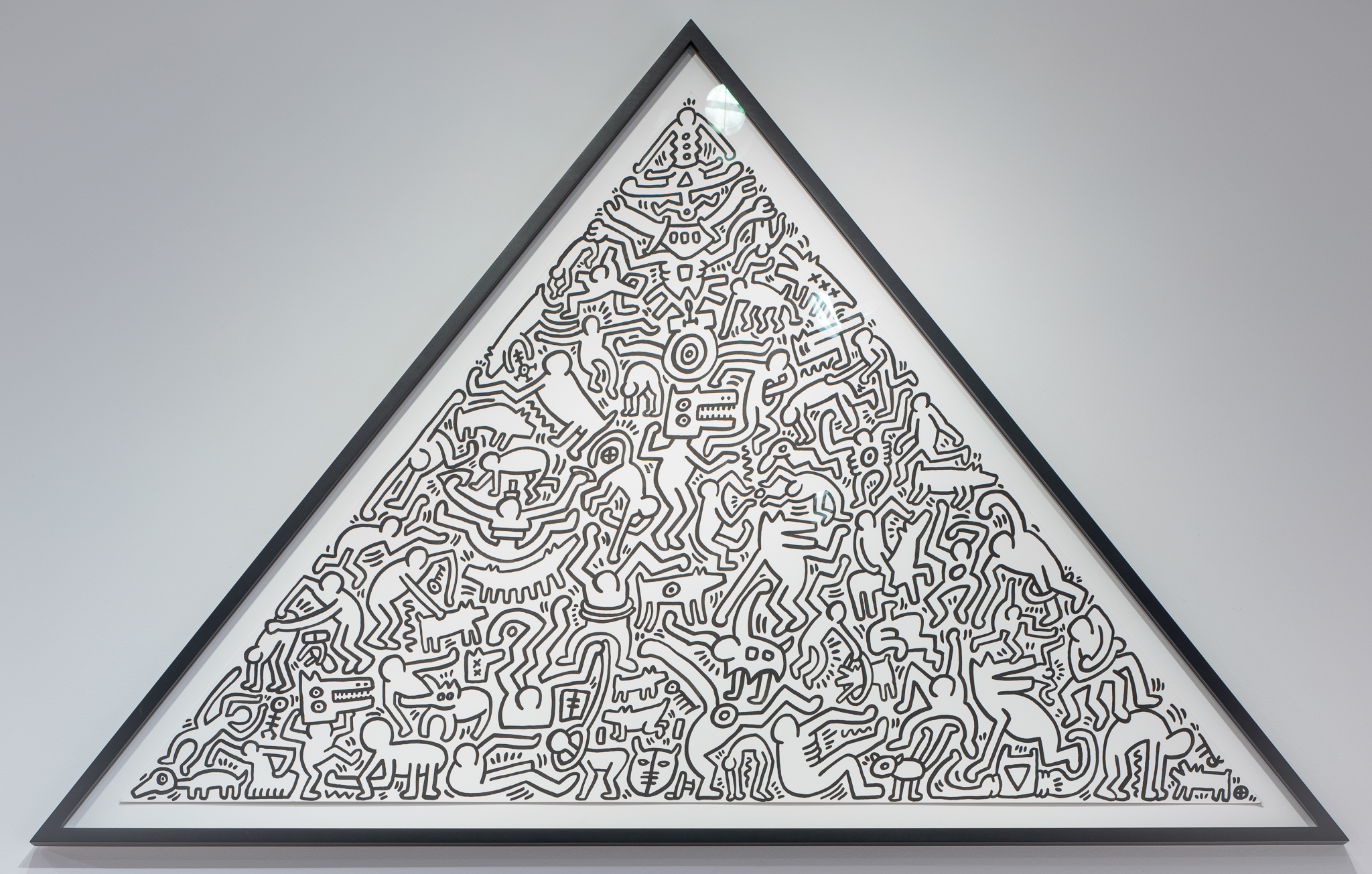 
		Keith Haring moved to New York in 1978, beginning a short but prolific career inspired by the city's rich outpouring of masterful urban graffiti, its flowering hip-hop culture, and the conceptual gap between “high” and “low” art. Haring developed a deceptively simple pictorial language in which he rendered form, setting, and emotional energy through little more than line and monochromatic accents of color. An AIDS diagnosis in 1988 did little to deter the artist's creative output. Untitled features dozens of Haring’s iconic characters, who seem to dance in a celebration of life, contorting wildly to music we cannot hear. Completed shortly before the artist’s death, the painting demonstrates Haring’s professional and personal ambition to infuse art with commentaries on global issues like the AIDS crisis. Haring saw his disease as a reason to celebrate living, not to fear pain or an inevitable end. Wishing to accept his impending death without regret and limitation, Haring explained,“No matter how long you work, it’s always going to end sometime. And there’s always going to be things left undone…. If you live your life according to that, death is irrelevant. Everything I’m doing right now is exactly what I want to do.” <a href="images/JSMA Research Guide-Keith Haring.pdf"
				target="_blank">Download this study guide.
	